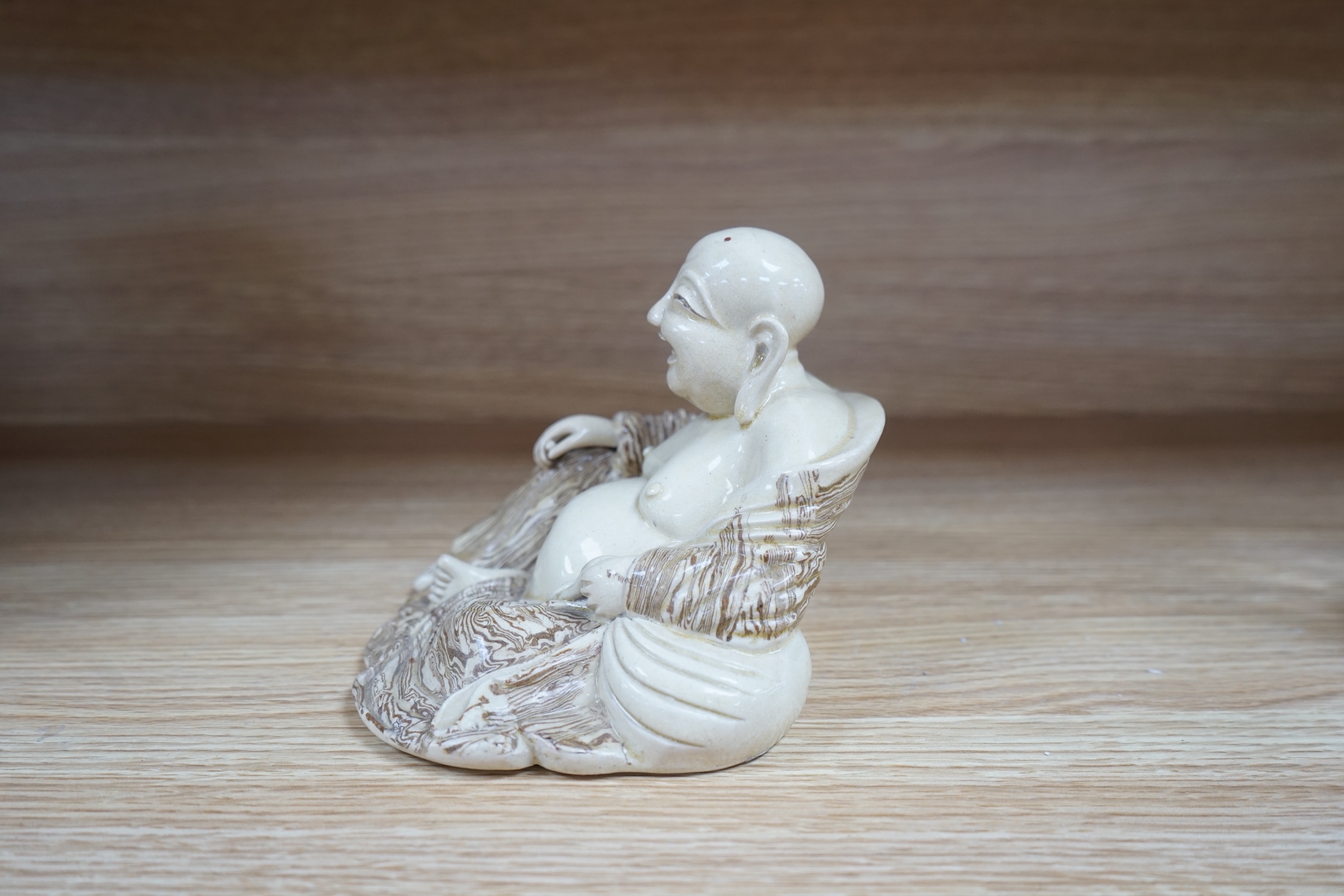 A Chinese marbled pottery figure of Budai, early 20th century, 13cm high. Condition - fair to good.